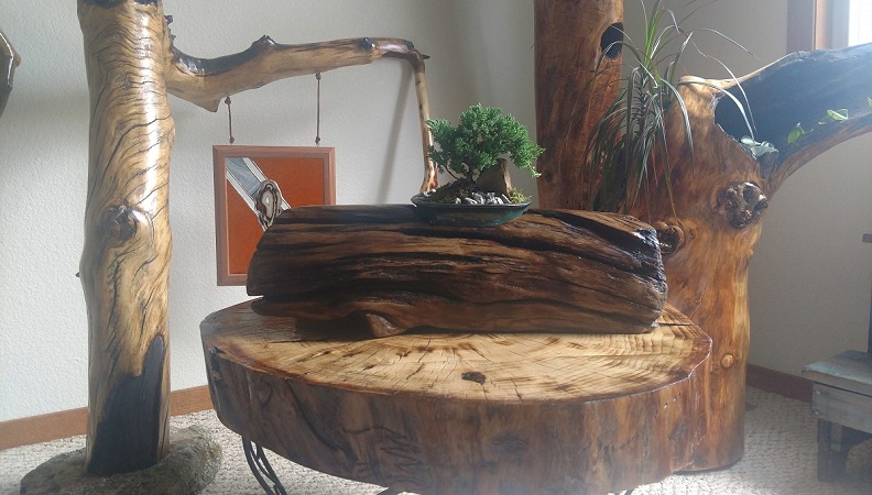 Several pieces of driftwood furtniture, including a table and planters